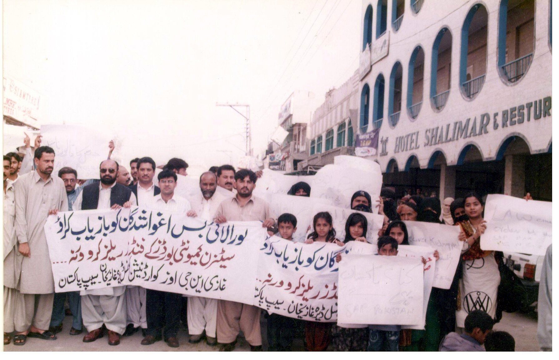 Community members participating in a public rights-awareness walk