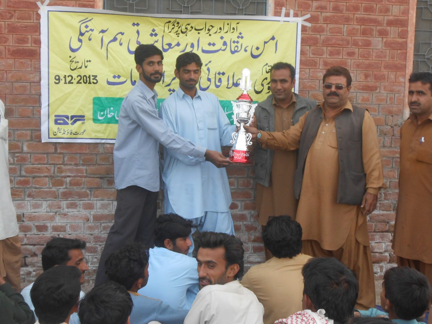 Participants receiving a trophy at an inclusive sports event