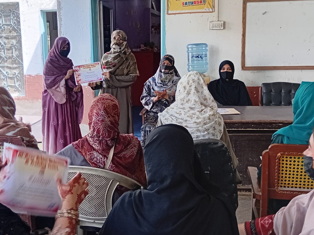 Woman receiving a certificate after completing a vocational training programme