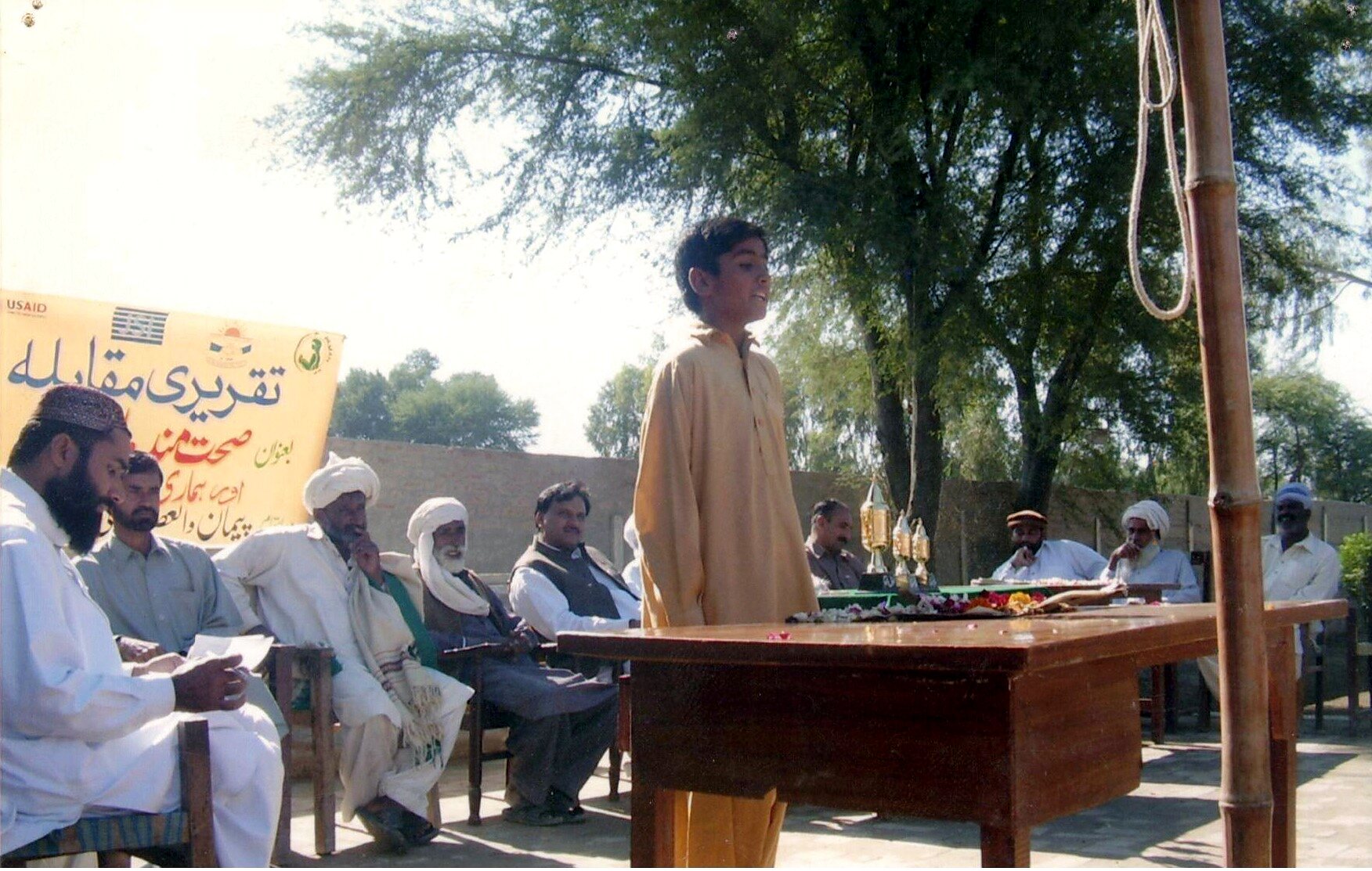 Outdoor community gathering for a Paiman health activity