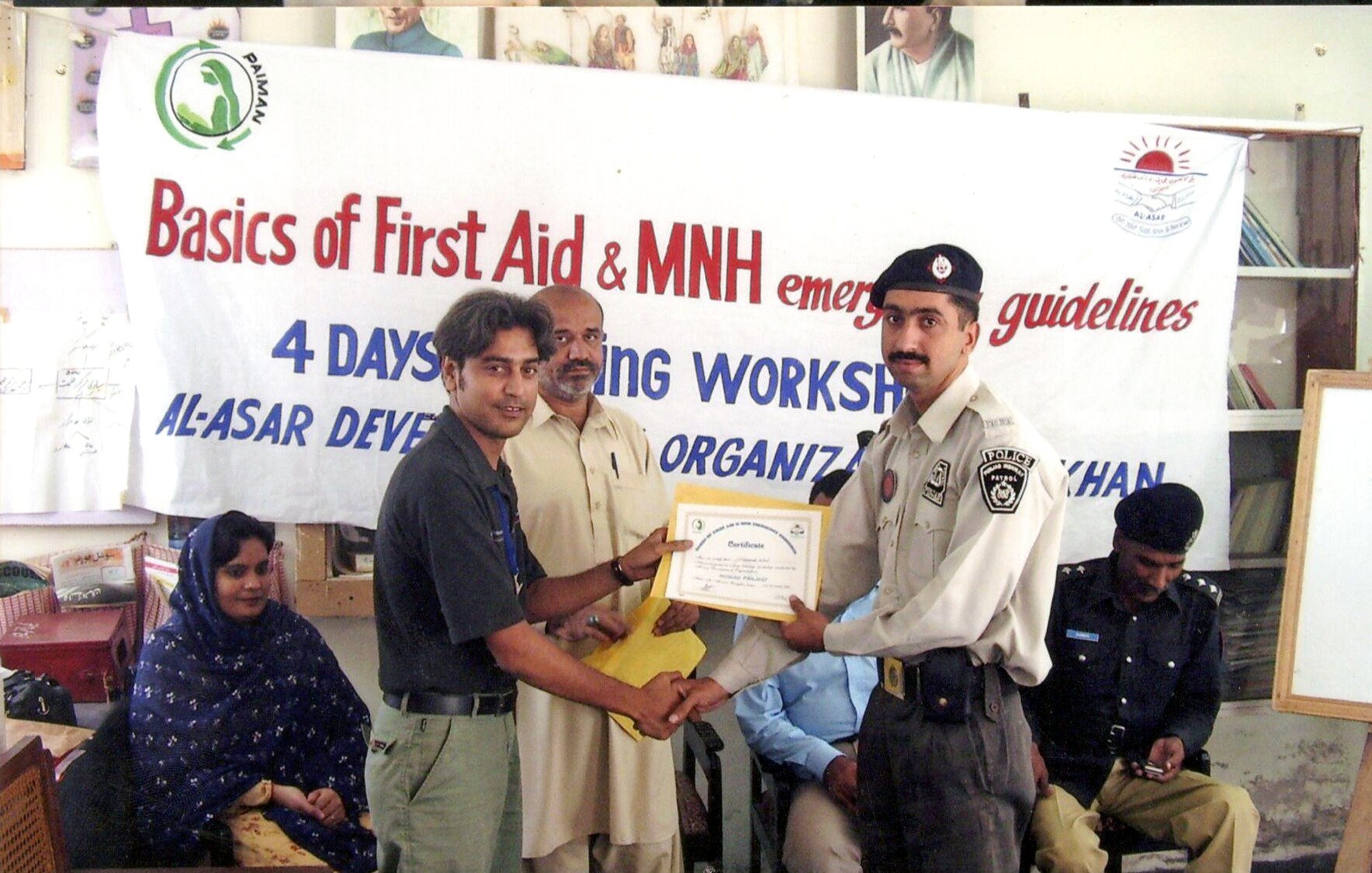 Participant receiving a certificate at a Paiman first-aid workshop