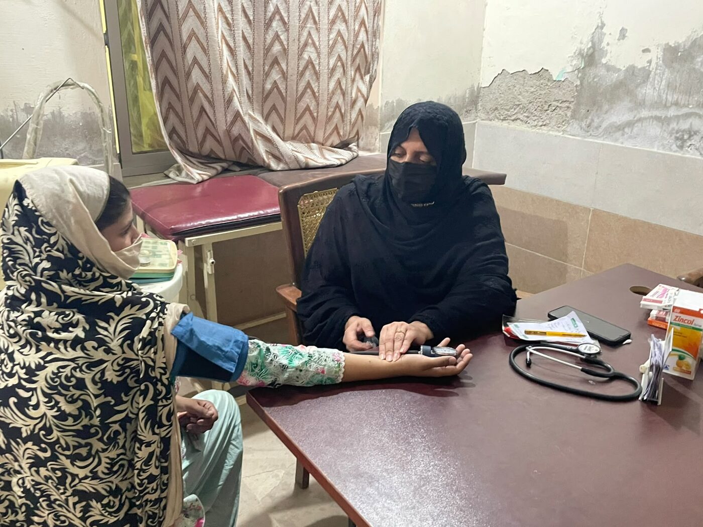Healthcare professional consulting a female patient
