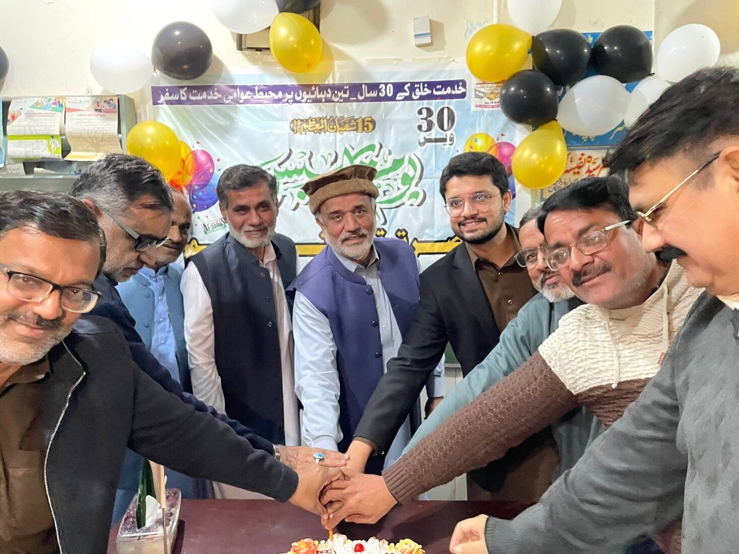 Al-Asar team and supporters marking thirty years of service